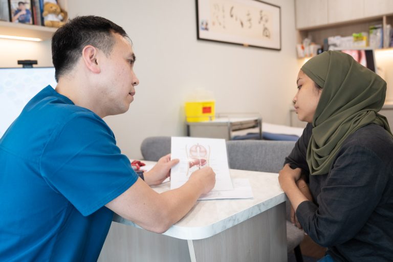 Consultation between surgeon, Dr Thomas Ho and female patient.